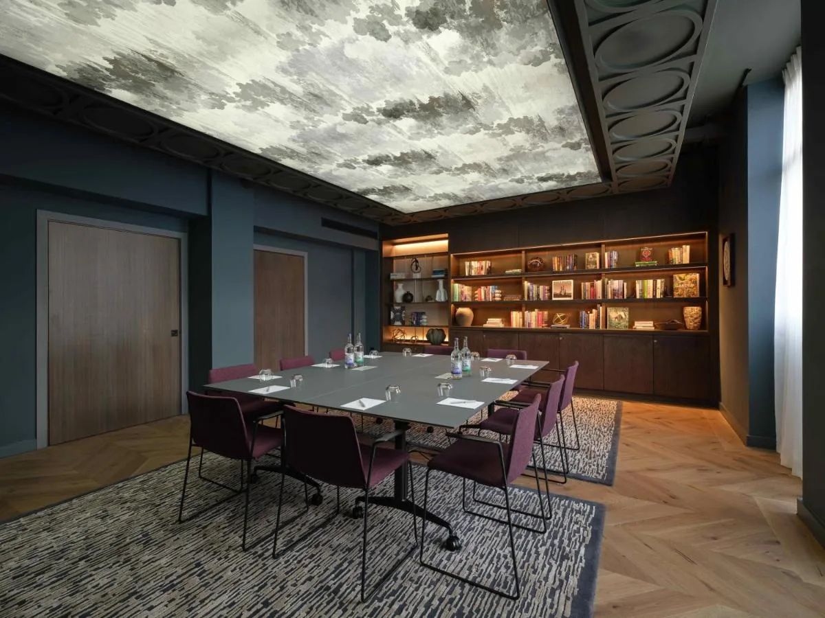 a conference room with a long table and purple chairs at The Resident Edinburgh in Edinburgh