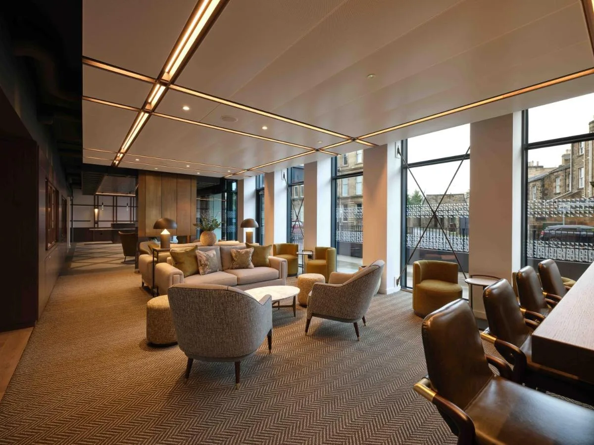a lobby with a waiting room with couches and chairs at The Resident Edinburgh in Edinburgh